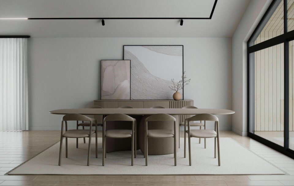 Aurora dining area with minimalist Scandinavian design, oval table and eight chairs, large window, and connection to kitchen and living room