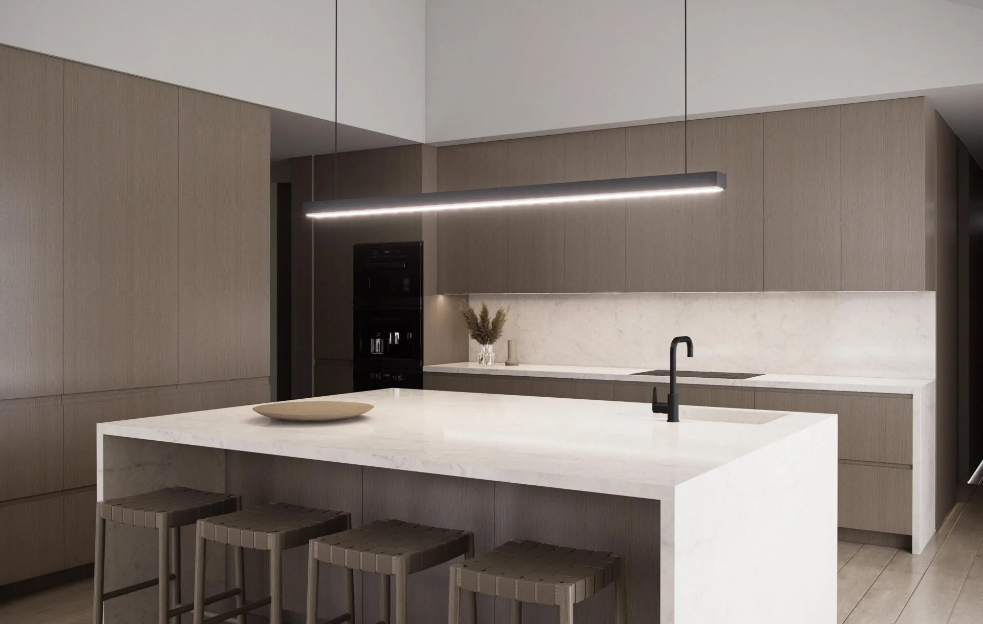 Aurora kitchen with island, wood cabinetry, integrated black appliances, linear pendant, and direct access from the main entry
