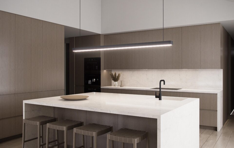 Aurora kitchen with island, wood cabinetry, integrated black appliances, linear pendant, and direct access from the main entry