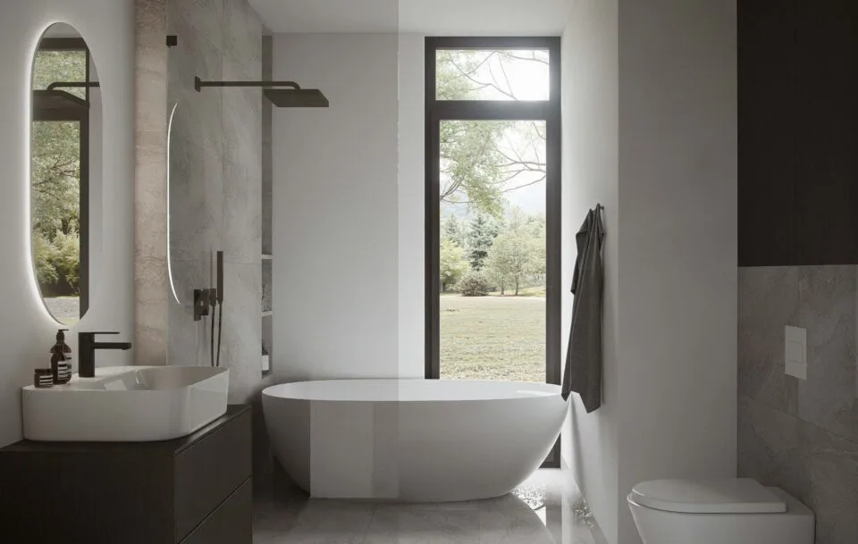 Lumina bathroom with freestanding tub, walk-in shower, single vanity sink, wall-hung toilet, and a floor-to-ceiling window bringing in natural light